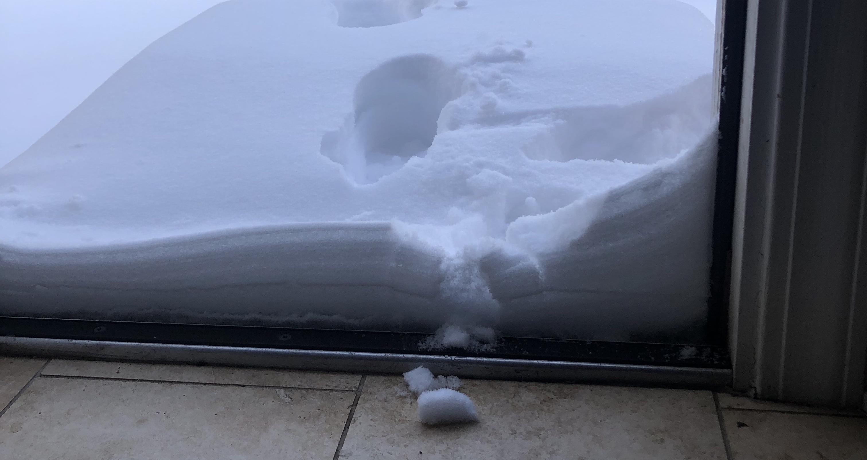 Layers of snow in a doorway